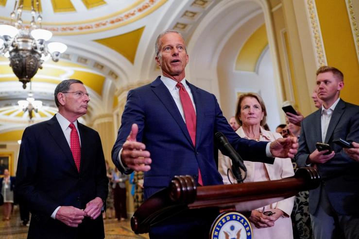 U.S. Senate Majority Leader John Thune looks on as Senate Republican leaders hold a press conference.