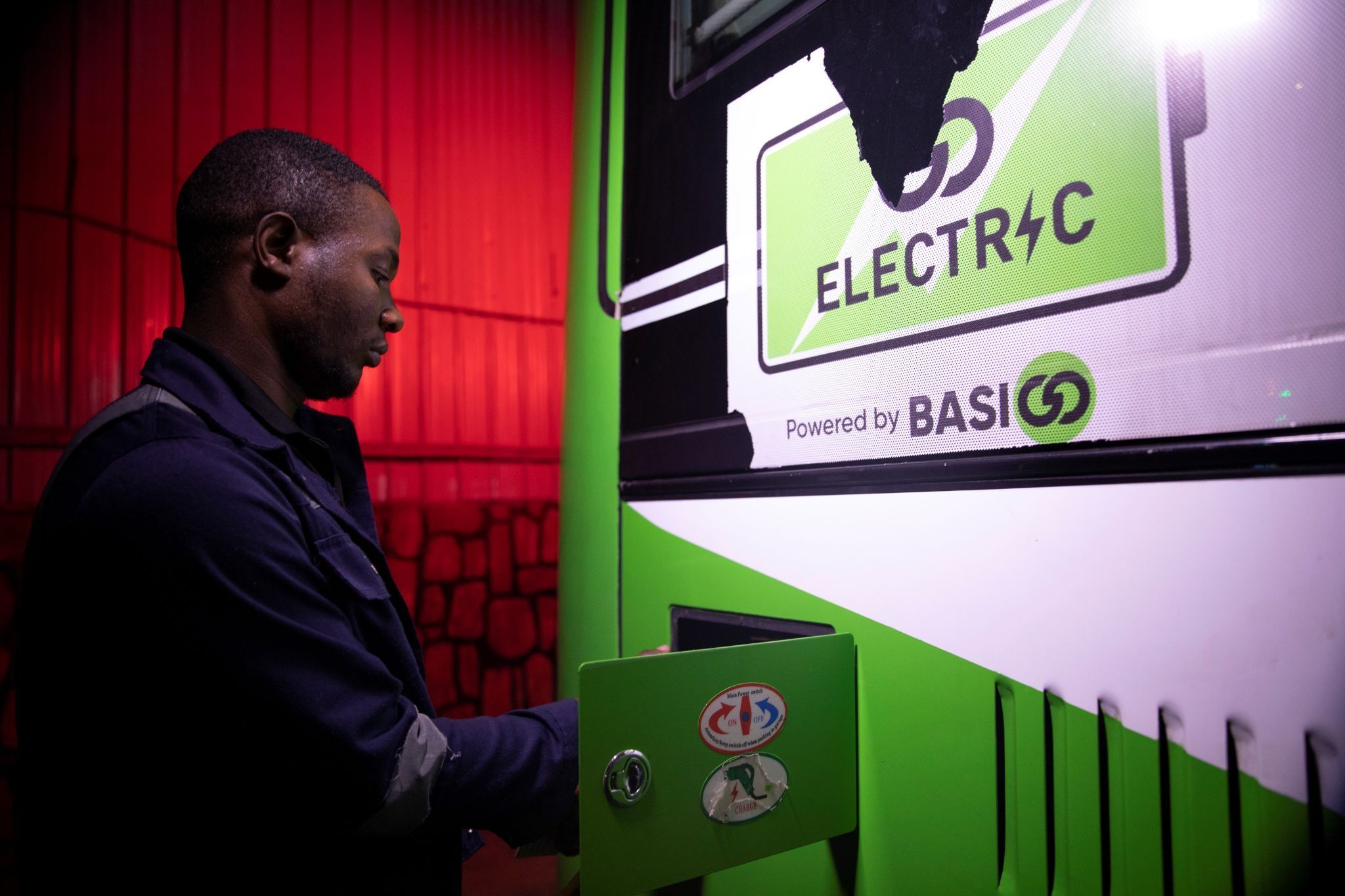 A worker charges an electric bus at a charging station in Kigali, Rwanda.