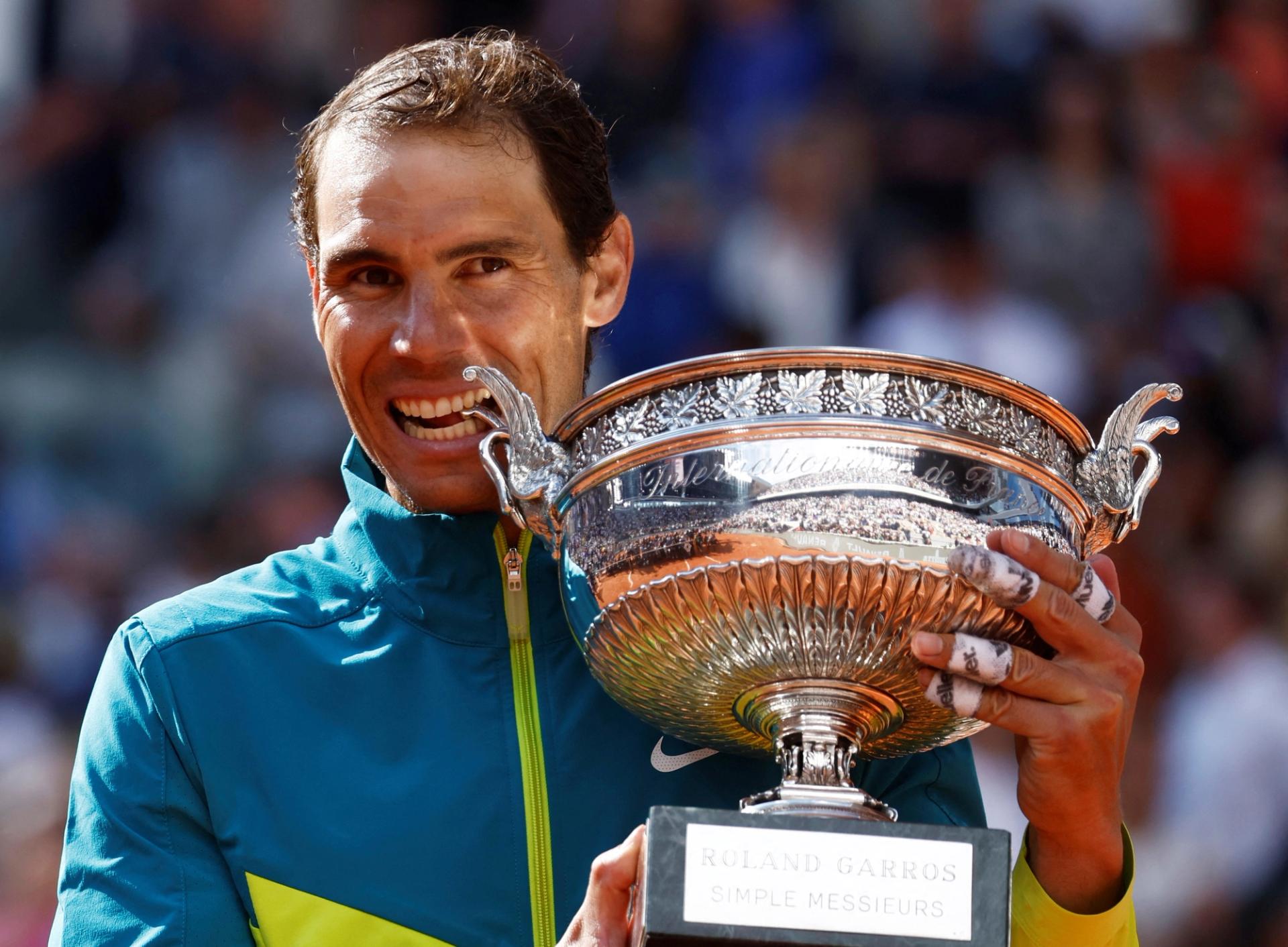 Rafael Nadal holding the Roland Garros trophy.