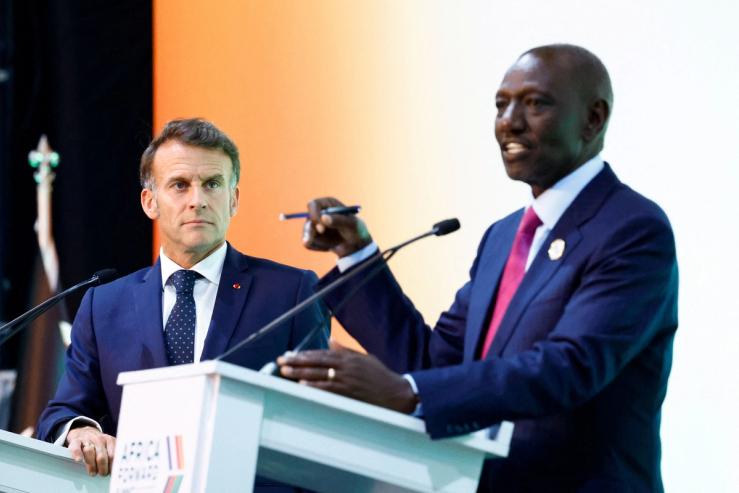 Kenya’s President William Ruto speaks next to French President Emmanuel Macron.