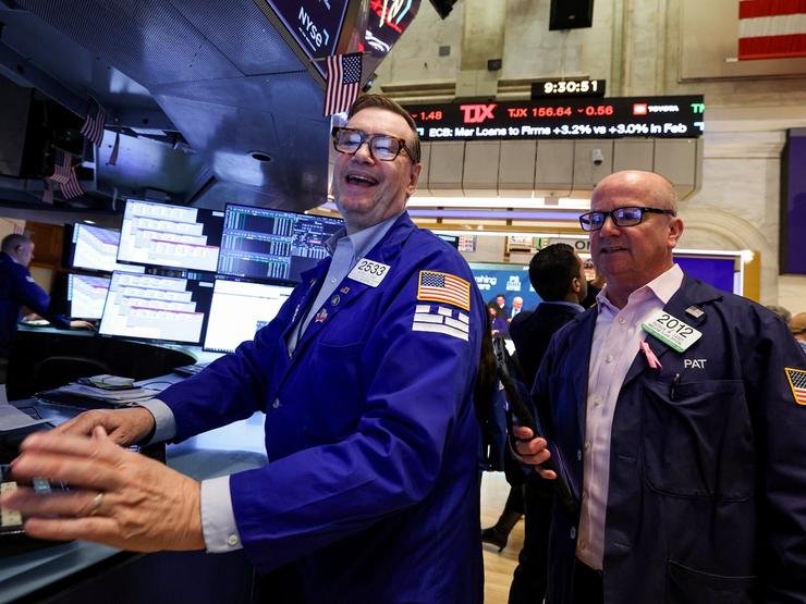 Traders work on the floor at the New York Stock Exchange