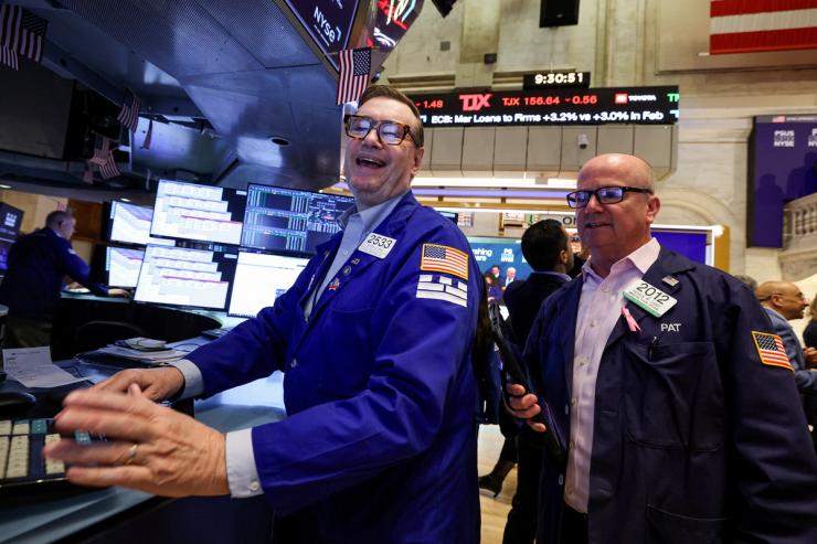 Traders work on the floor at the New York Stock Exchange