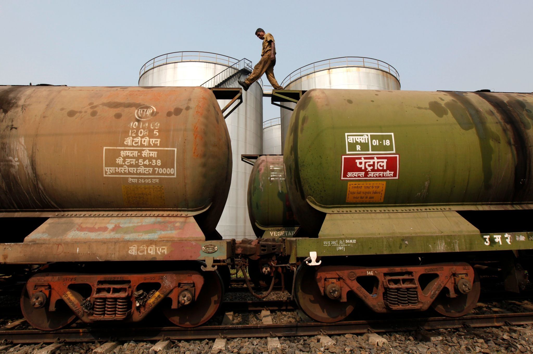 A worker walks atop a tanker wagon in Kolkata. 