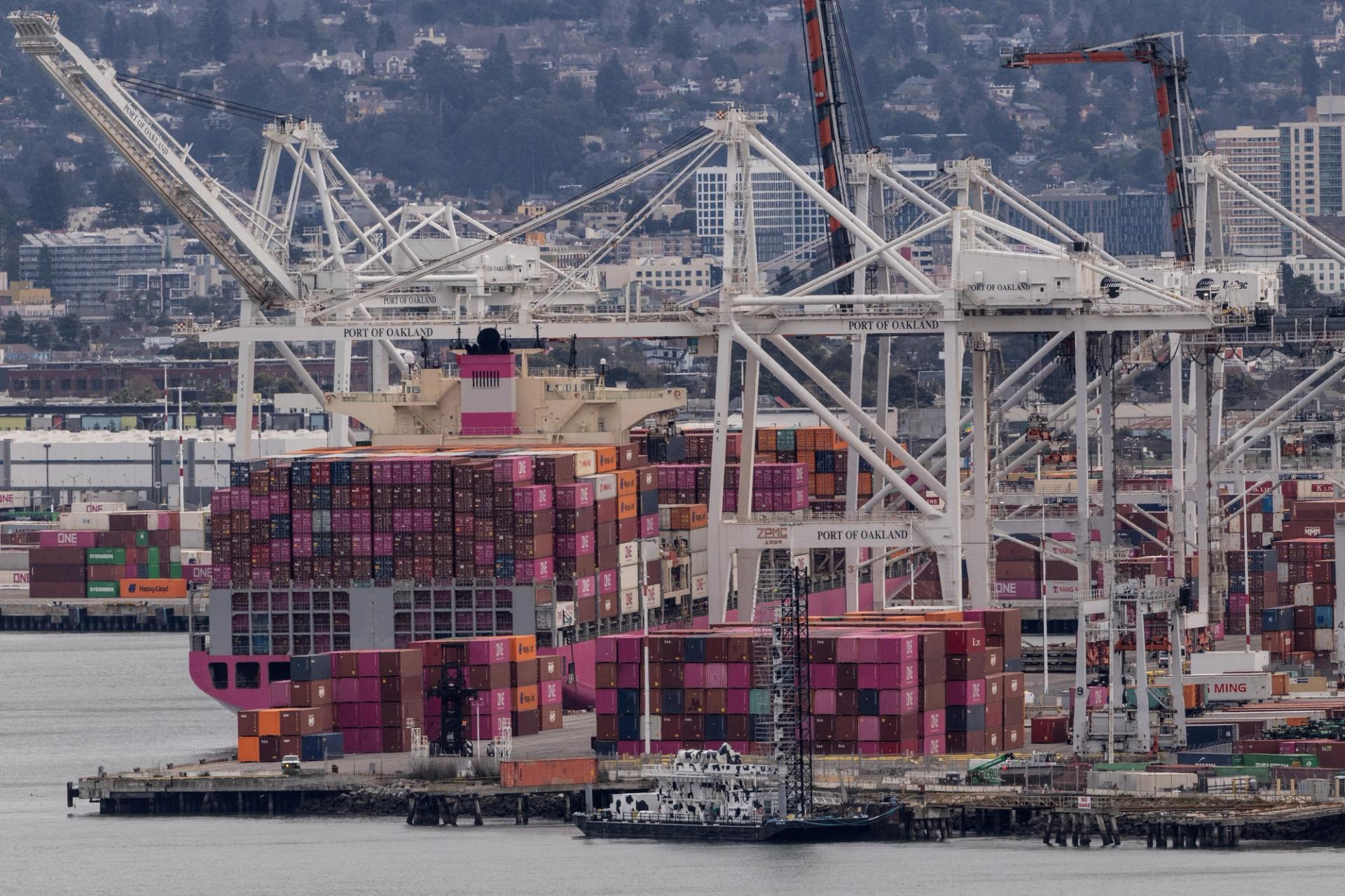 A cargo ship full of shipping containers is seen at the port of Oakland.