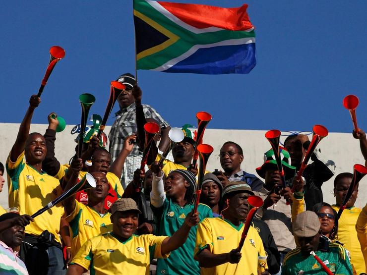 Football fans blow vuvuzelas during the 2010 World Cup.