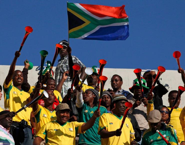 Football fans blow vuvuzelas during the 2010 World Cup.