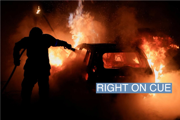 A French firefighter works to extinguish a burning car during the fifth day of protests following the death of Nahel, a 17-year-old teenager killed by a French police officer in Nanterre during a traffic stop, in Tourcoing, France, July 2, 2023. REUTERS/Pascal Rossignol
