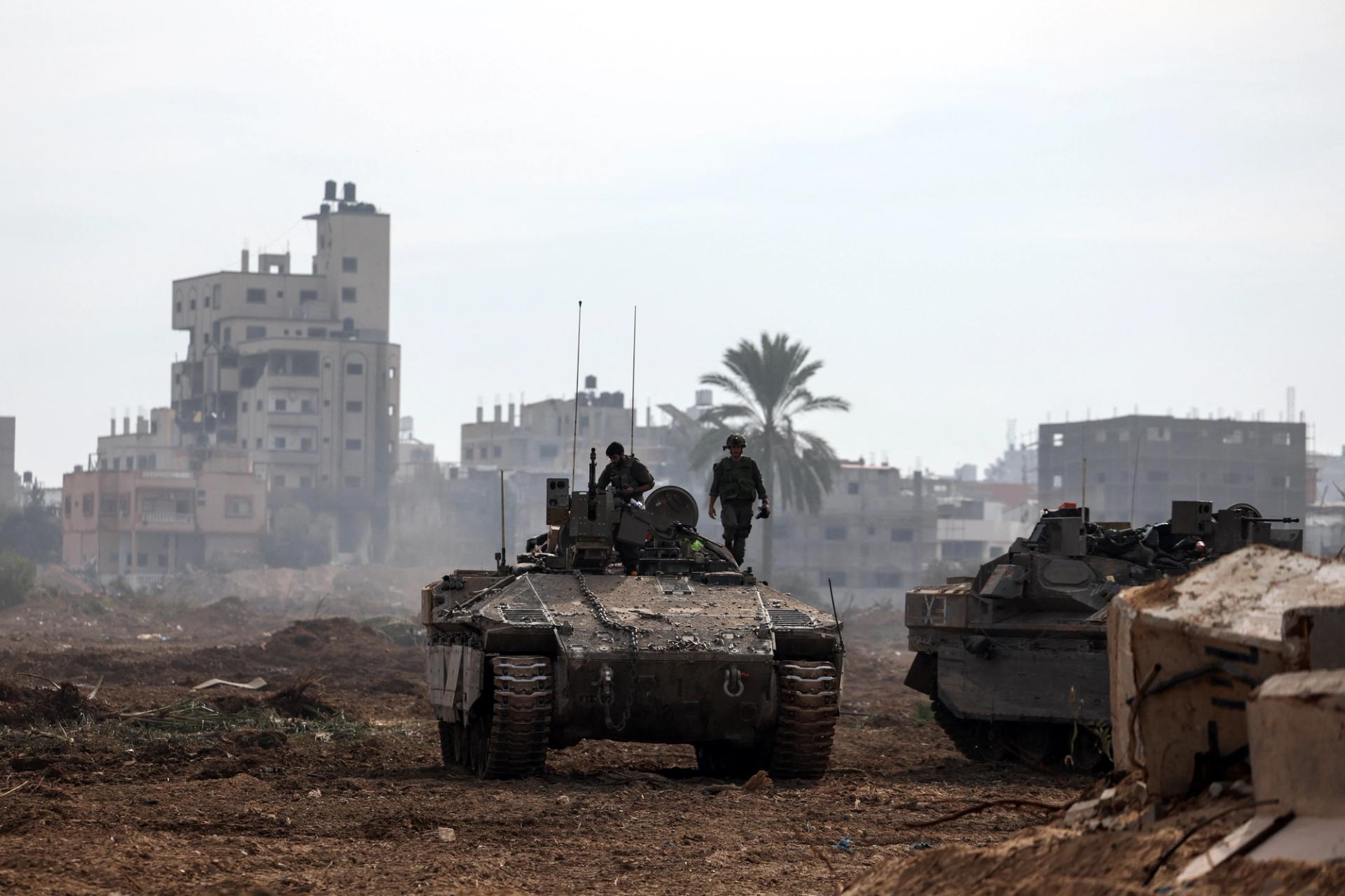 Israeli soldiers stand on an Israeli armoured personnel carrier (APC) as they operate, amid the ongoing conflict between Israel and the Palestinian Islamist group Hamas, in Gaza, January 8, 2024. REUTERS/Ronen Zvulun