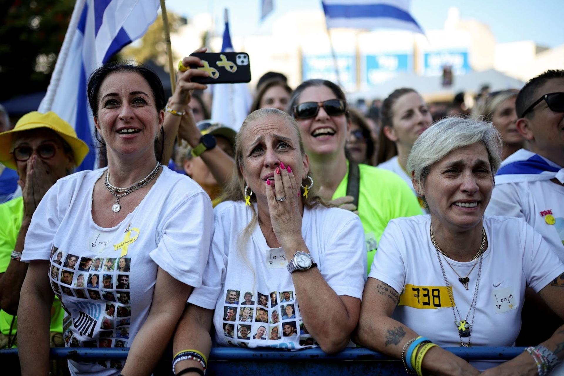 Women react at “Hostage Square.” 