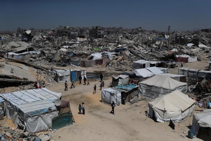 Palestinians displaced by the Israeli military offensive, shelter in tents near the rubble of houses in Jabalia refugee camp.