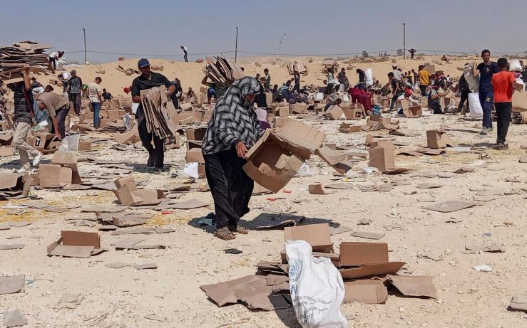 Palestinians gather to collect what remains of relief supplies from the distribution center of the U.S.-backed Gaza Humanitarian Foundation, in Rafah.