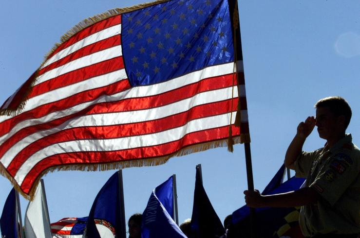 A Boy Scout salutes the flag on the one-year anniversary of the 9/11 attacks in Washington.
