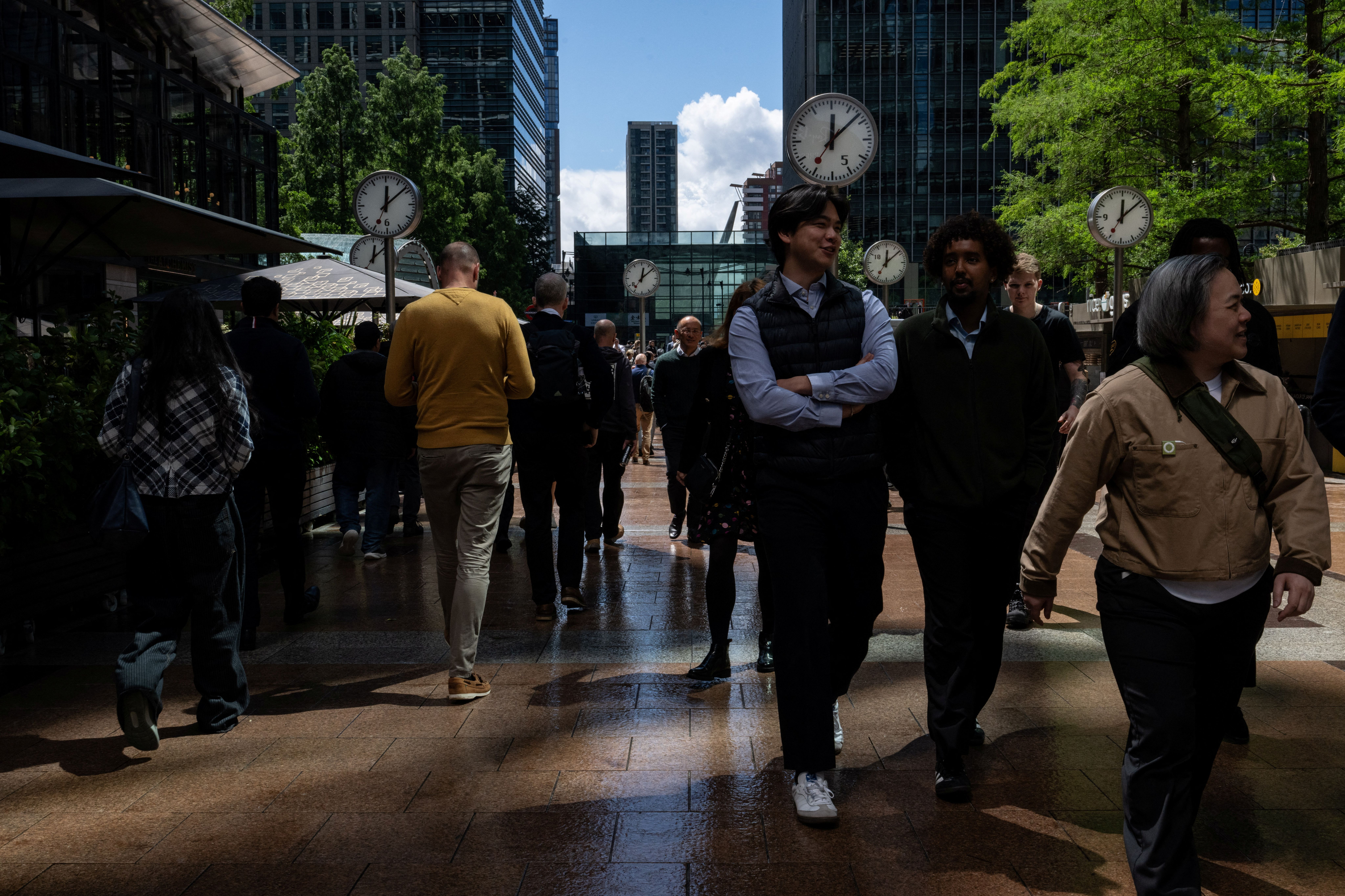 Workers walk through Canary Wharf on their lunch breaks in London