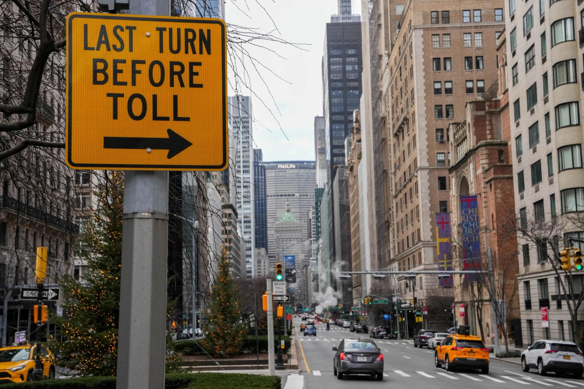 Vehicles pass Congestion Zone signage and E-ZPass readers in New York.