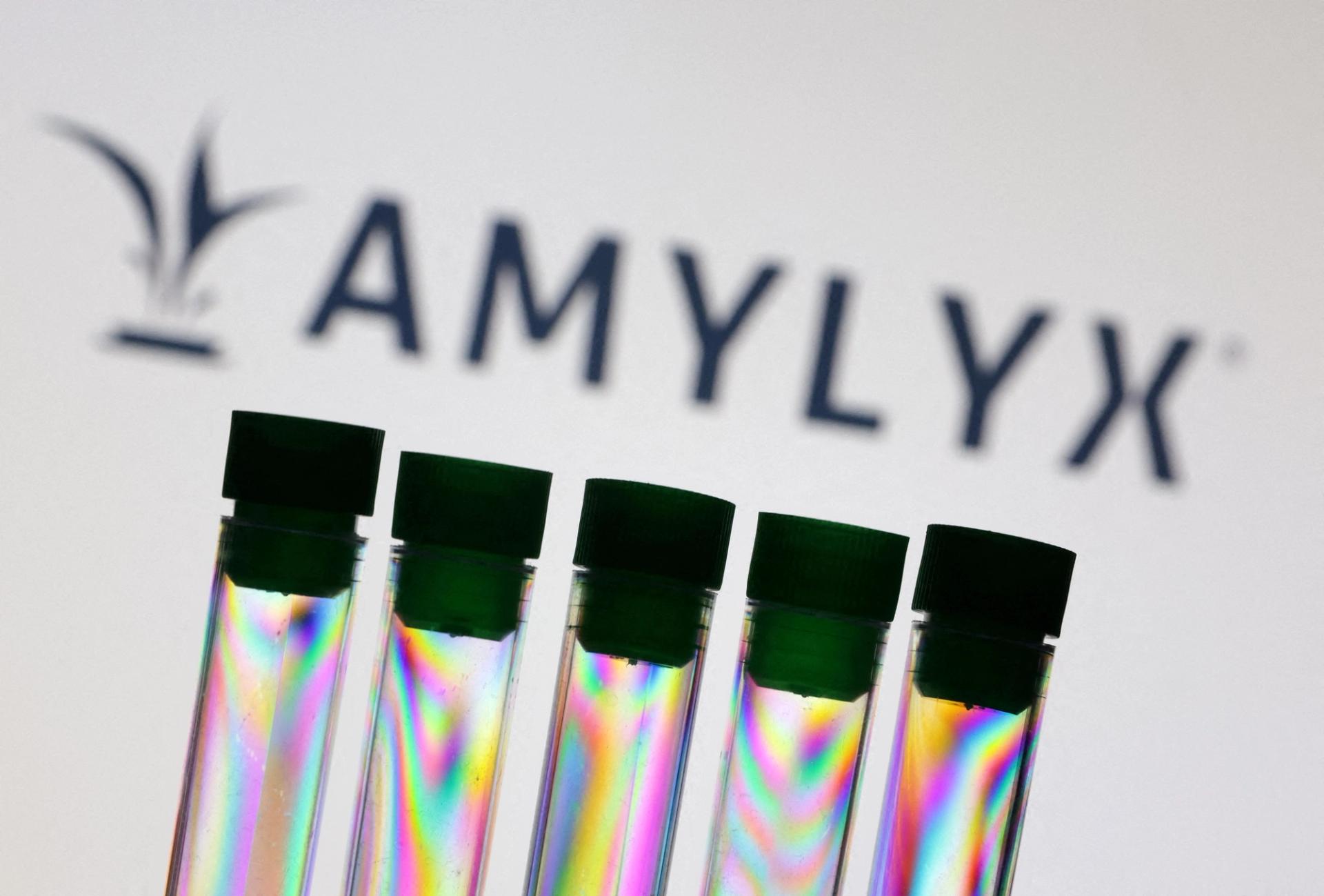 Test tubes are seen in front of Amylyx logo.