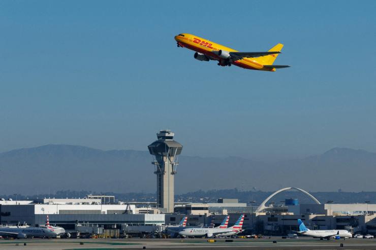 A DHL cargo plane takes-off from Los Angeles International Airport in Los Angeles, California