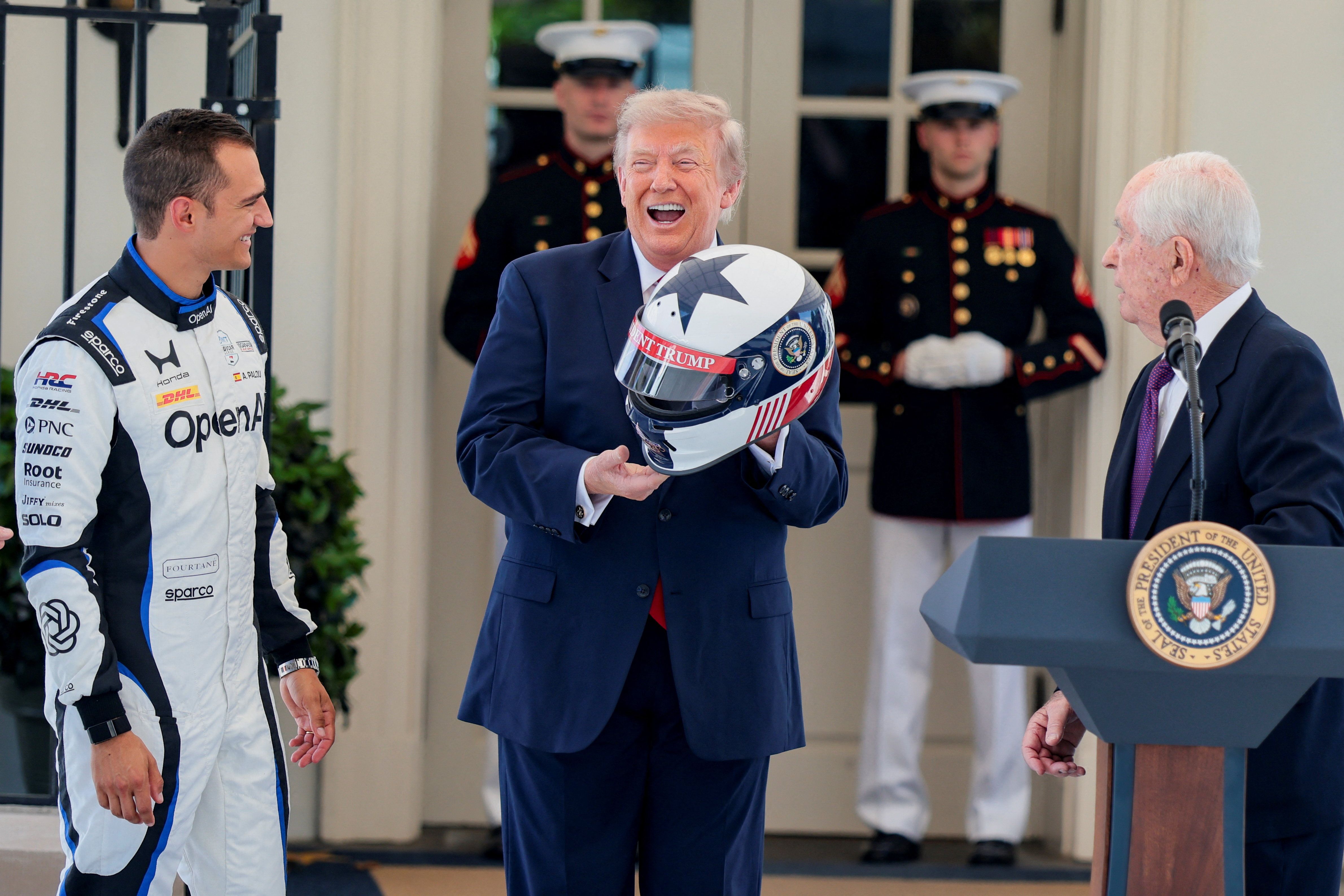 President Donald Trump, next to IndyCar series owner Roger Penske and IndyCar series driver Alex Palou