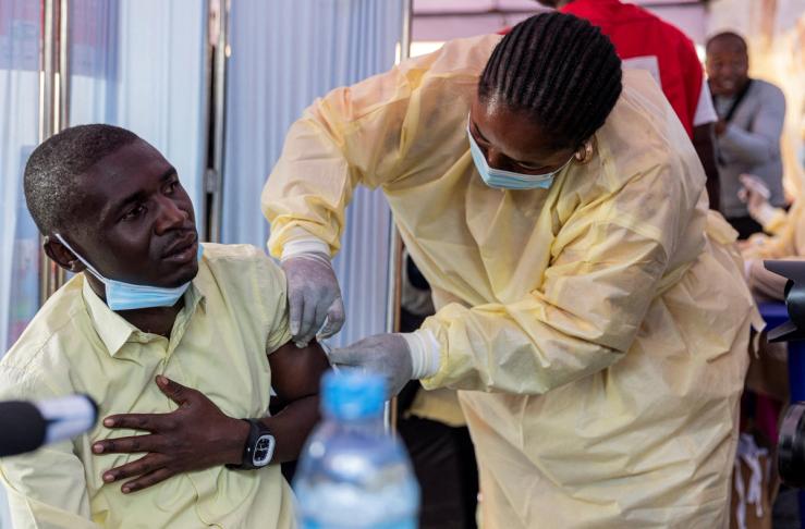 A Congolese health official administers a mpox vaccination to a man in Goma.