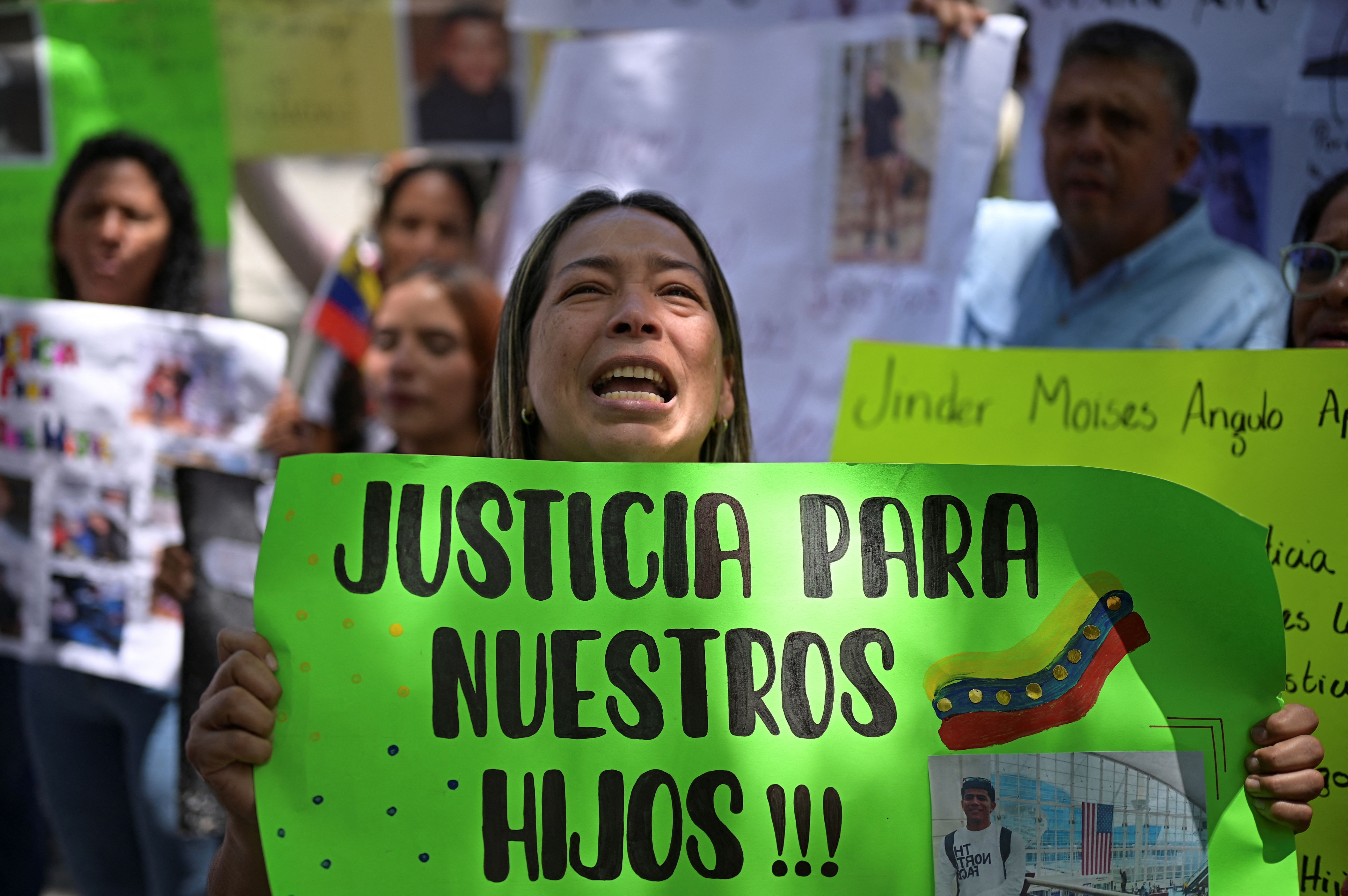 A family member of a Venezuelan who is held in a high-security prison in El Salvador after being deported from the U.S., holds a sign that reads “Justice for our sons”, during a protest to demand their release, in Caracas, Venezuela.