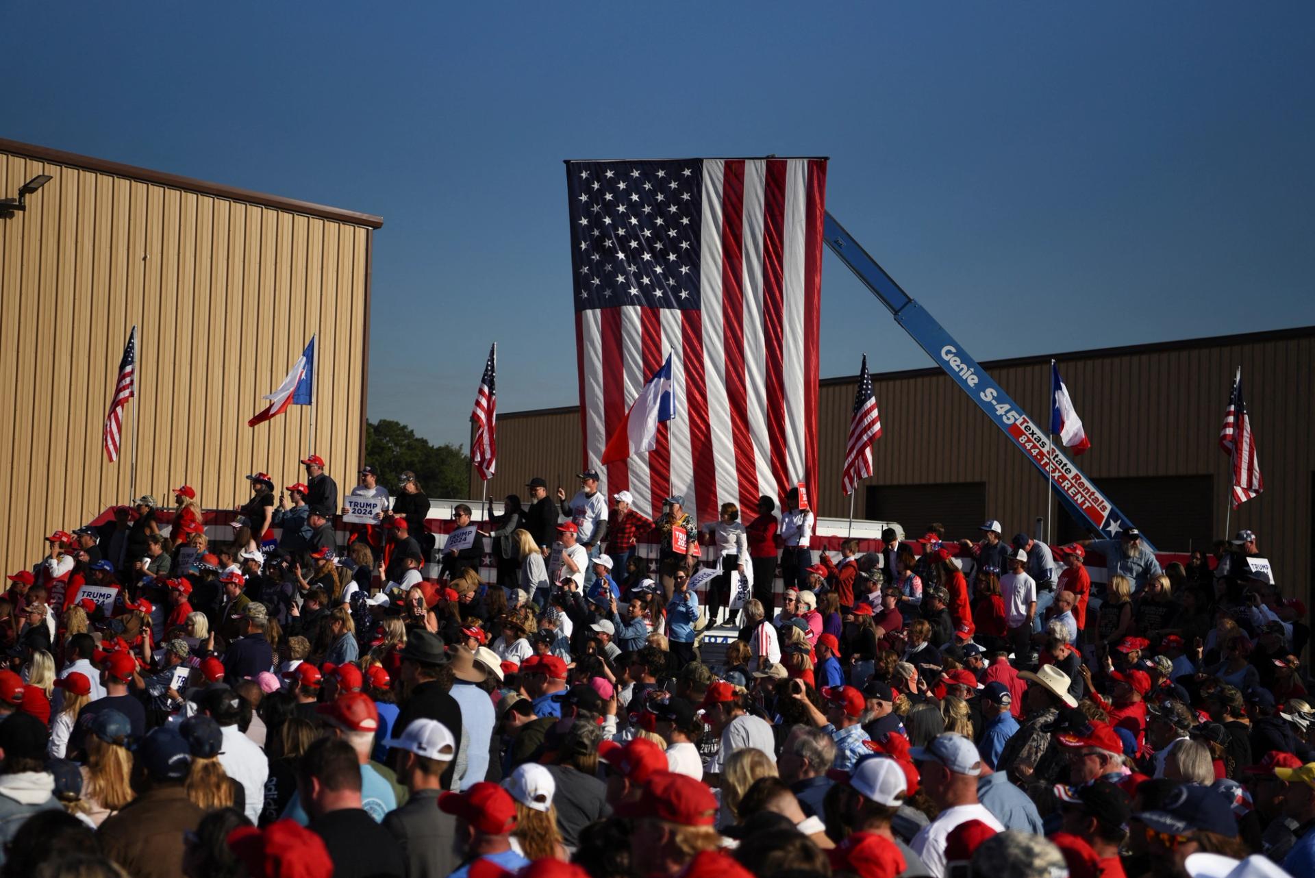 Supporters listen as Republican presidential candidate and former US President Donald Trump addresses the crowd during a campaign rally in Houston, Texas.