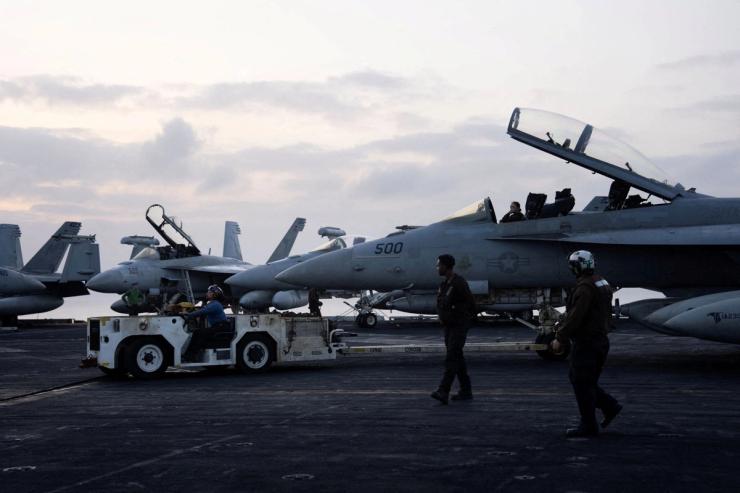 US fighter jets sit on the flight deck of the USS George Washington in the Arabian Sea.