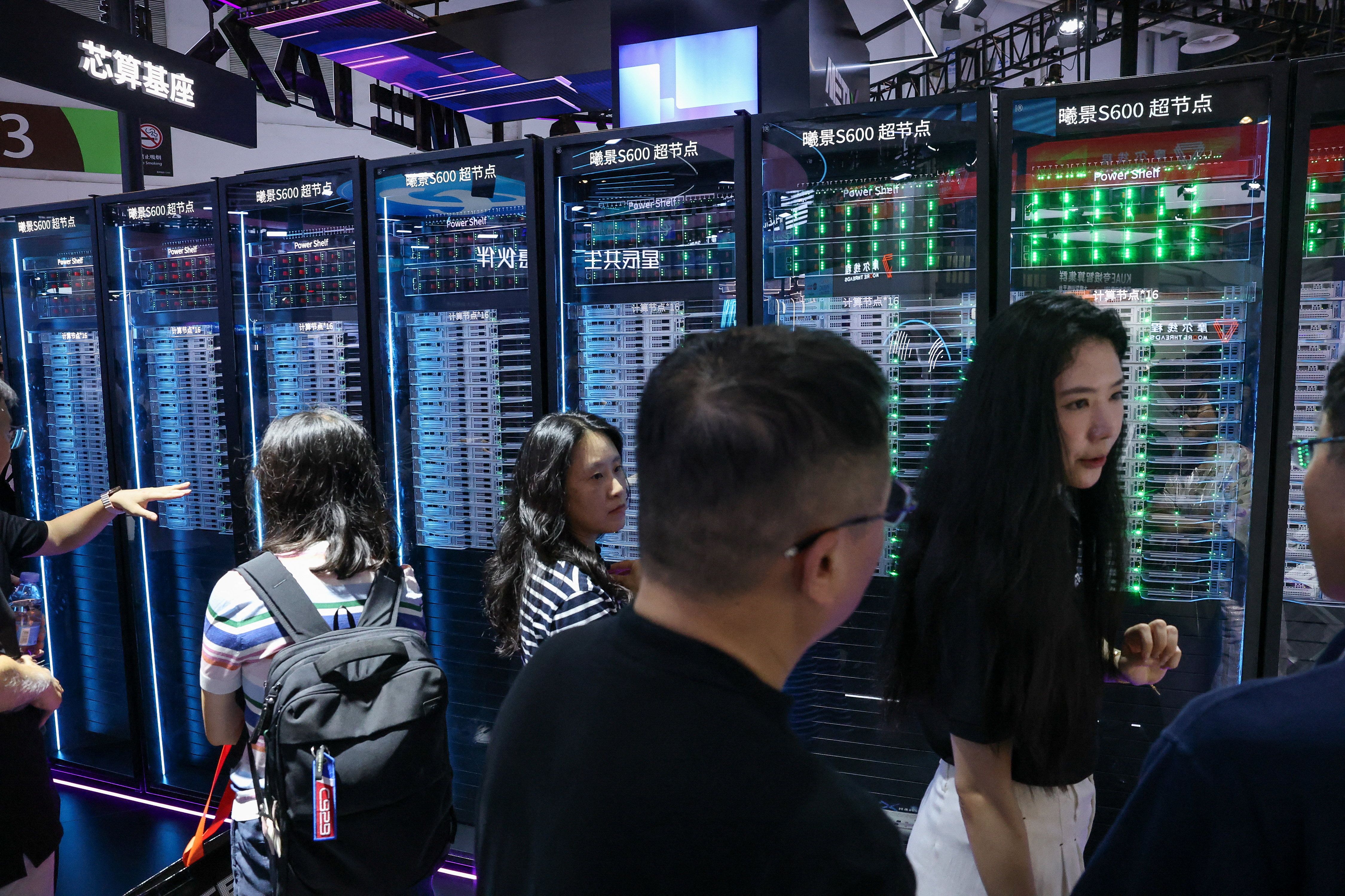 People visit the MetaX booth, where the Xijing S600 AI Supernode is displayed, during the World Artificial Intelligence Conference (WAIC) in Shanghai.