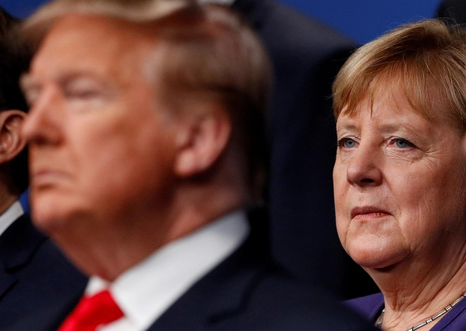 U.S. President Donald Trump and Germany’s Chancellor Angela Merkel pose for the family photo during the annual NATO heads of government summit at the Grove Hotel in Watford, Britain December 4, 2019. 