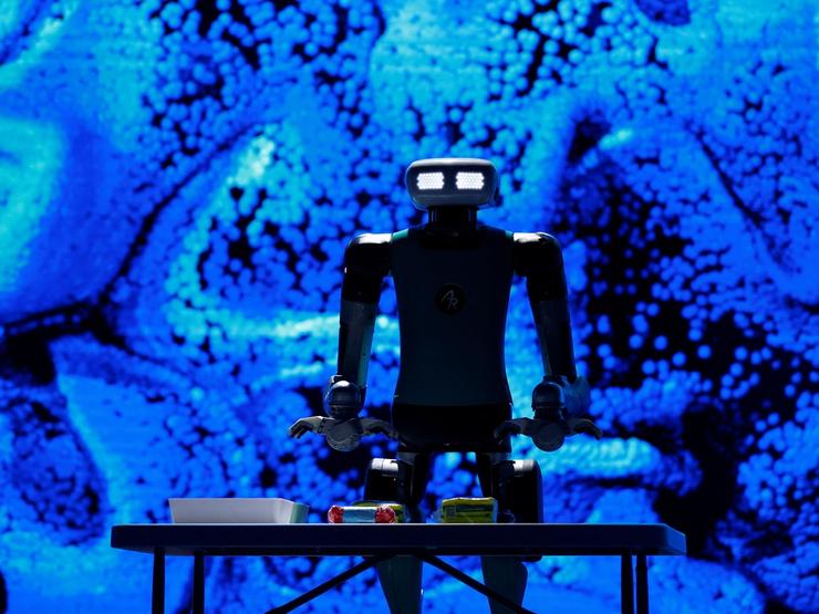 A robot stands above a table
