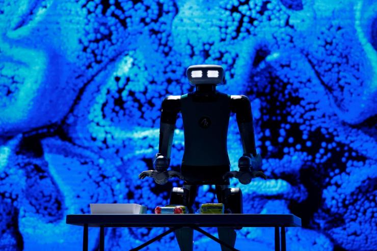 A robot stands above a table