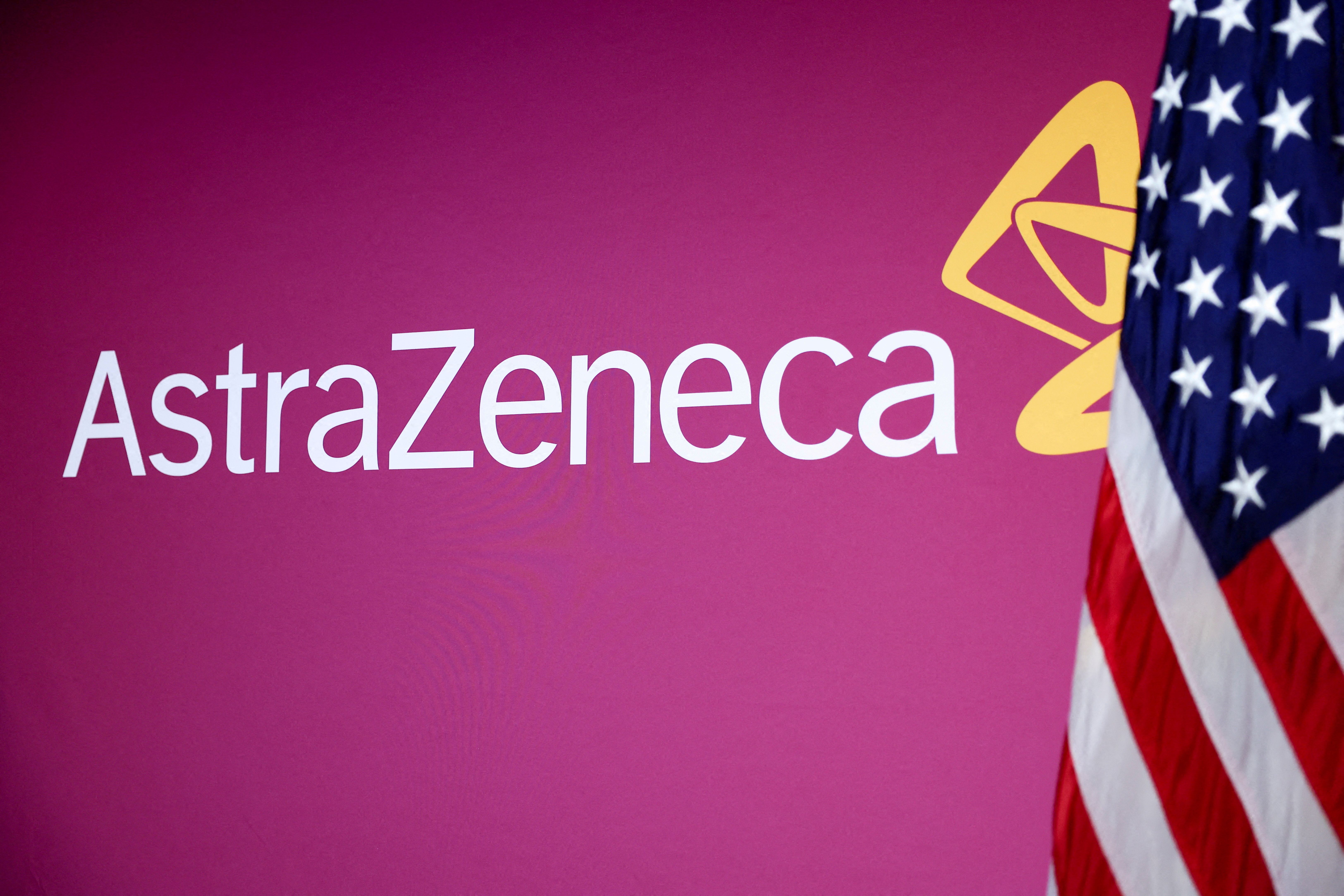 A US flag stands next to the AstraZeneca logo