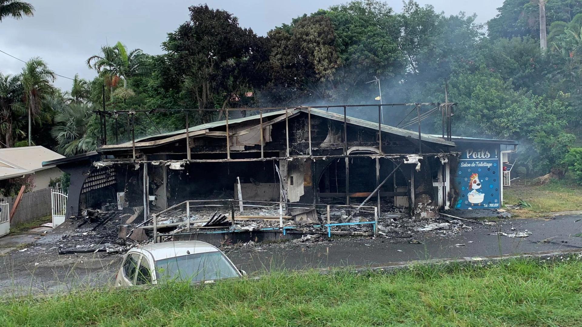 A damaged building is seen as rioters protest against plans to allow more people to take part in local elections in the French-ruled territory, which indigenous Kanak protesters reject, in Noumea, New Caledonia, May 15, 2024, in this picture obtained from social media.