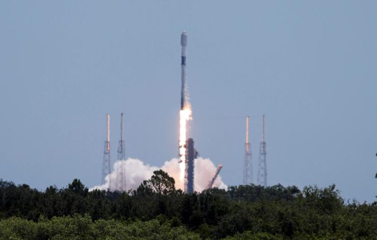 A SpaceX Falcon 9 rocket carrying Starlink satellites lifts off