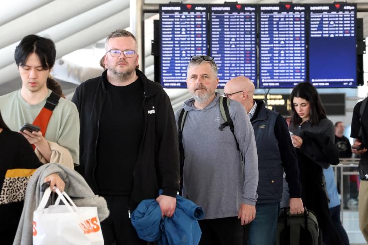 People wait in security lines at New York’s John F. Kennedy International Airport