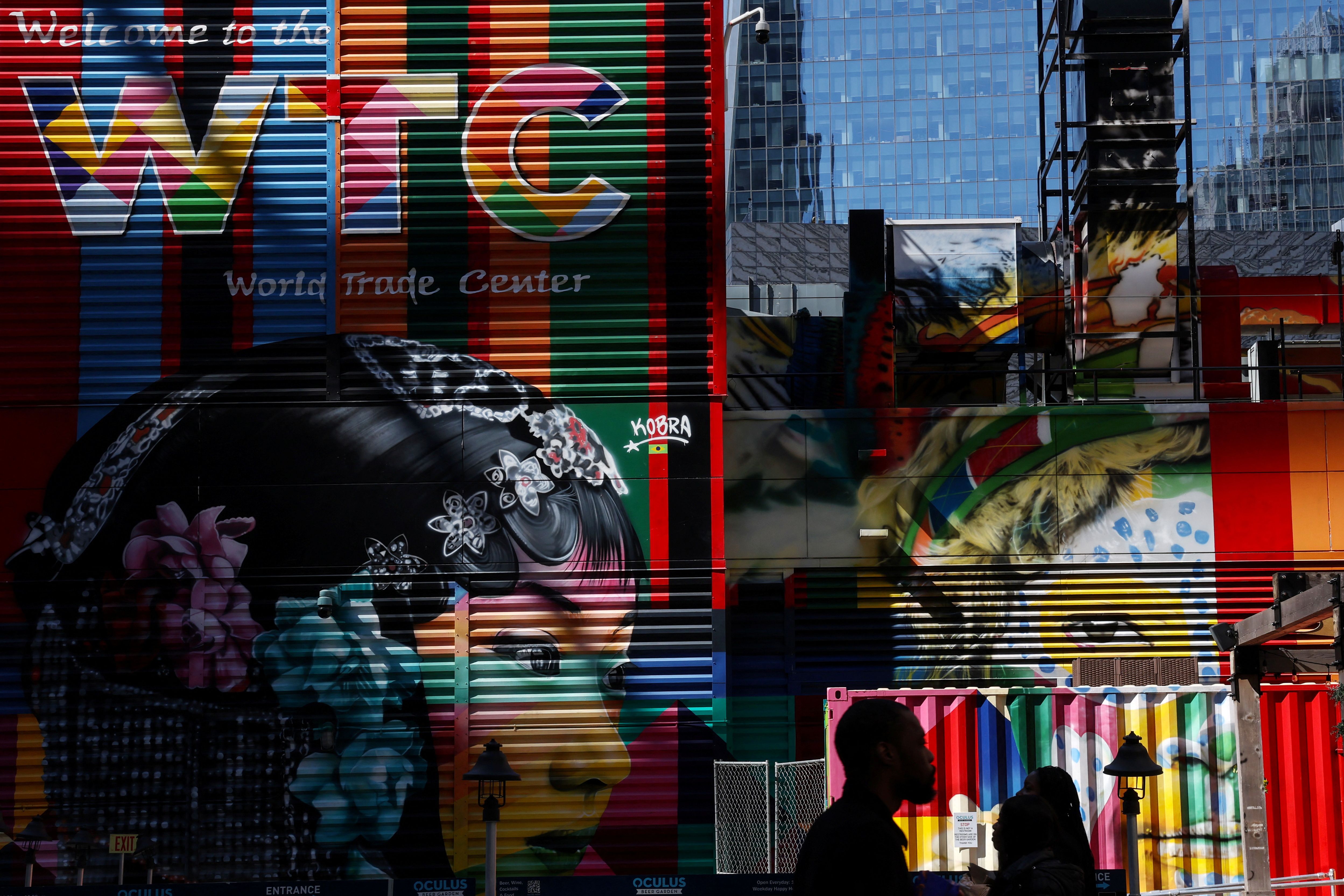 People walk in silhouette near the World Trade Center site in New York City, US. 
