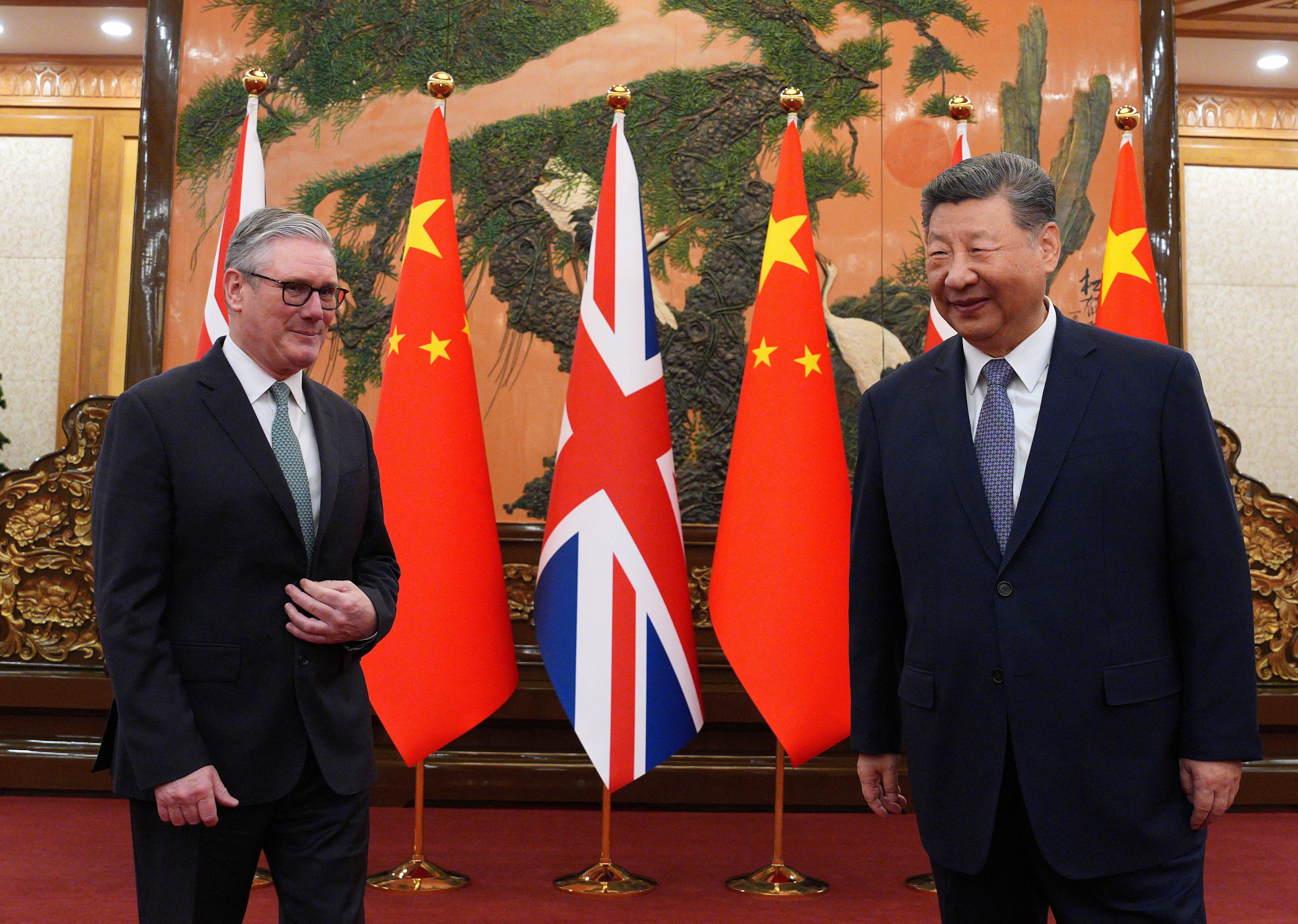 Britain’s Prime Minister Keir Starmer greets Chinese President Xi Jinping
