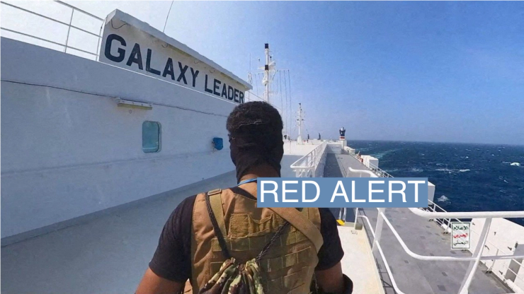 A Houthi fighter stands on the Galaxy Leader cargo ship in the Red Sea in this photo released November 20, 2023