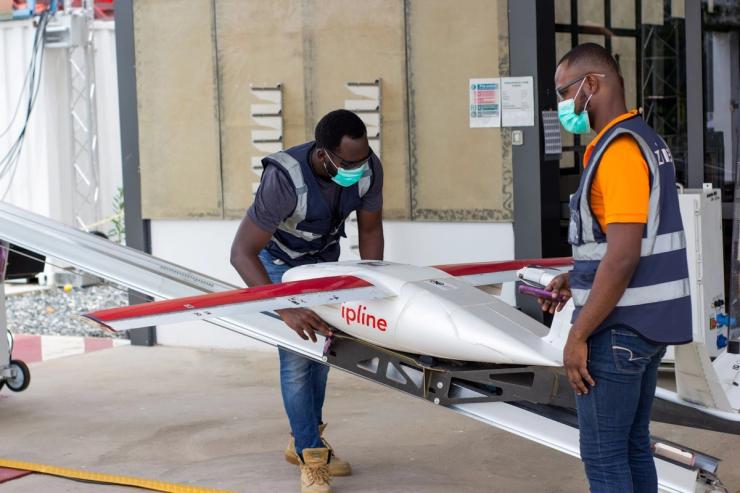 Flight operators perform pre-flight checks on a Zipline drone on April 16, 2020.