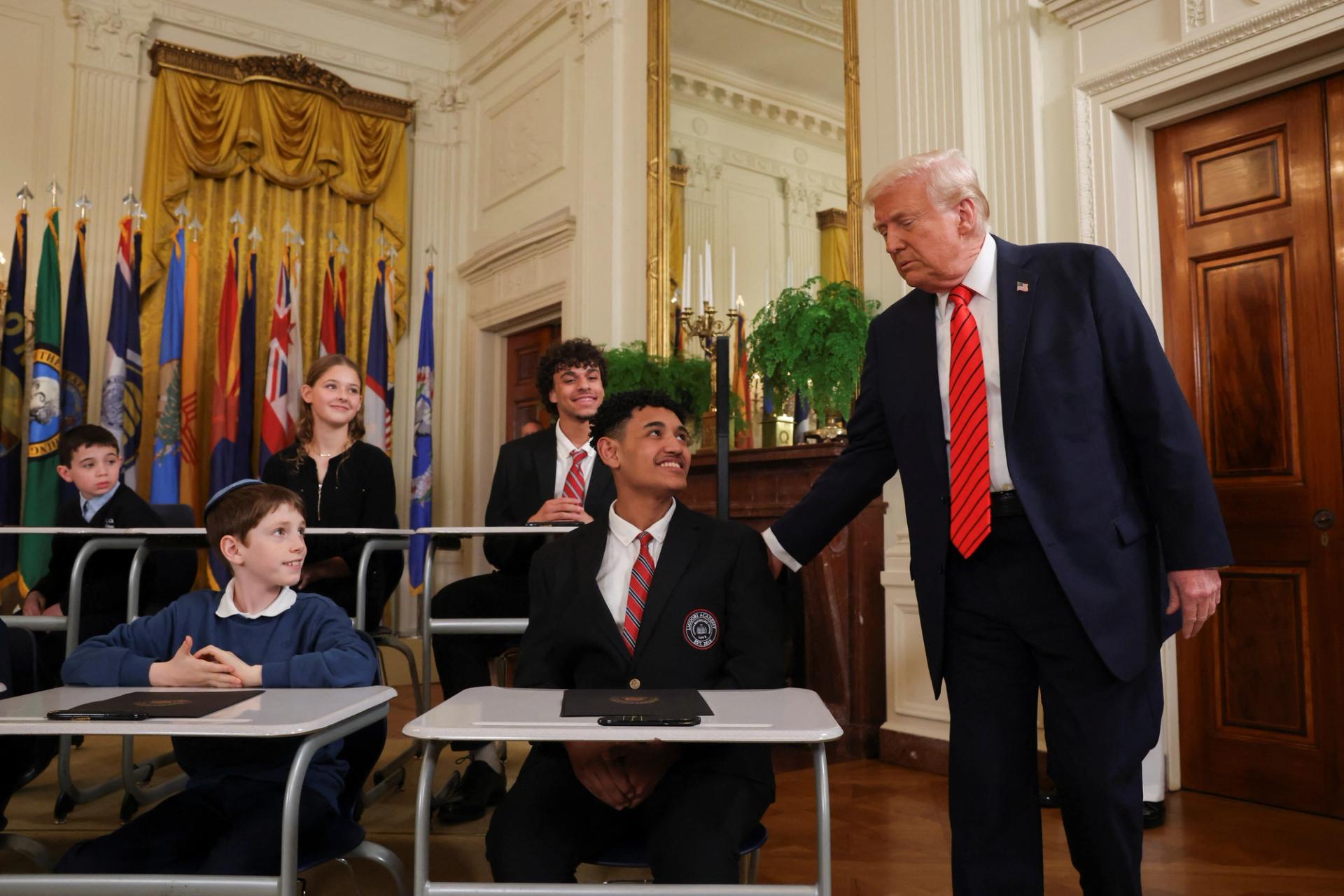 U.S. President Donald Trump greets students during an event to sign an executive order to shut down the Department of Education.