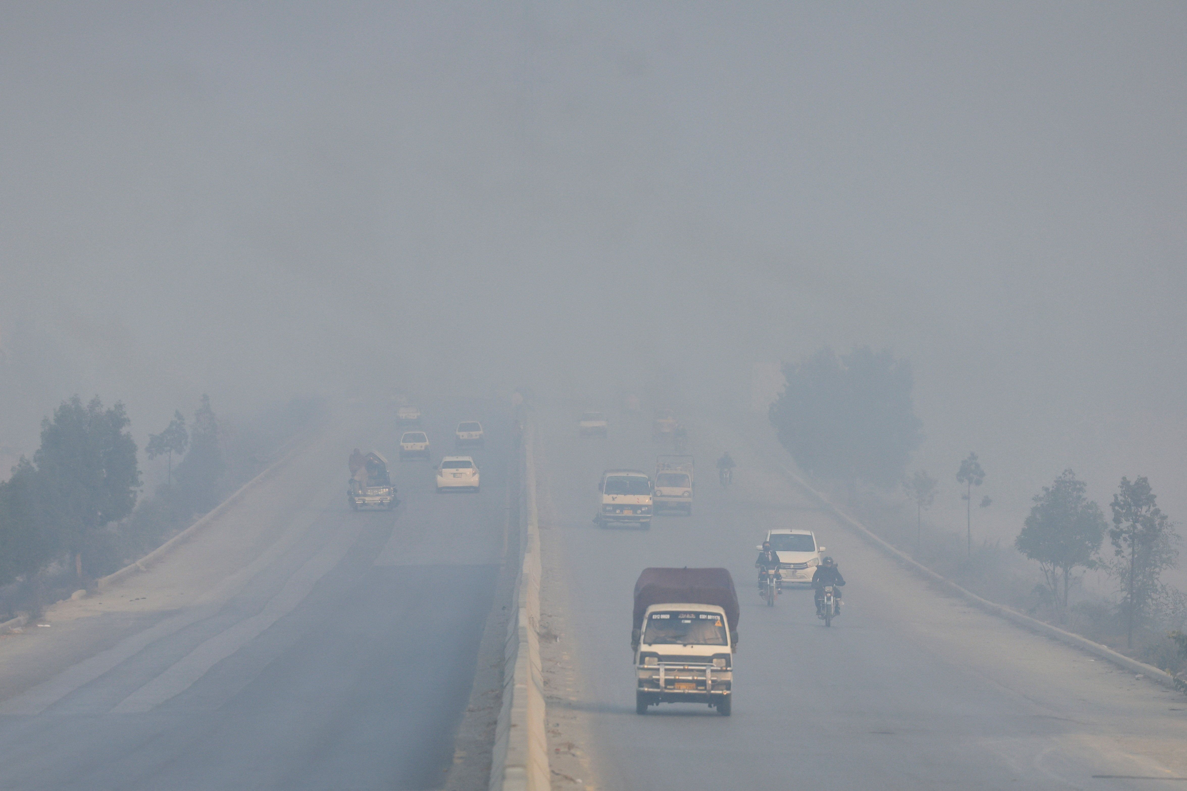 Vehicles move amid smog and air pollution during morning hours in Peshawar, Pakistan.