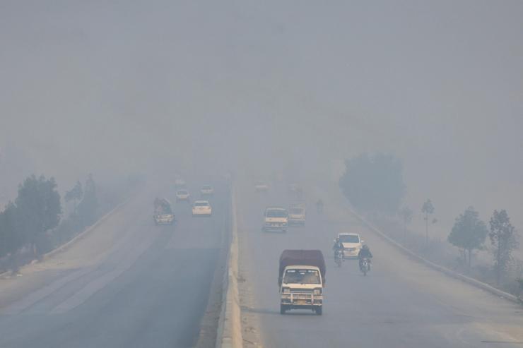 Vehicles move amid smog and air pollution during morning hours in Peshawar, Pakistan.