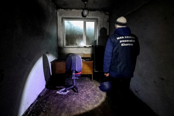 A war crime prosecutor inspects a basement where prosecutor’s office says 30 people were held for two months during the Russian occupation, amid Russia’s attack on Ukraine, in Kherson, Ukraine December 20, 2022.