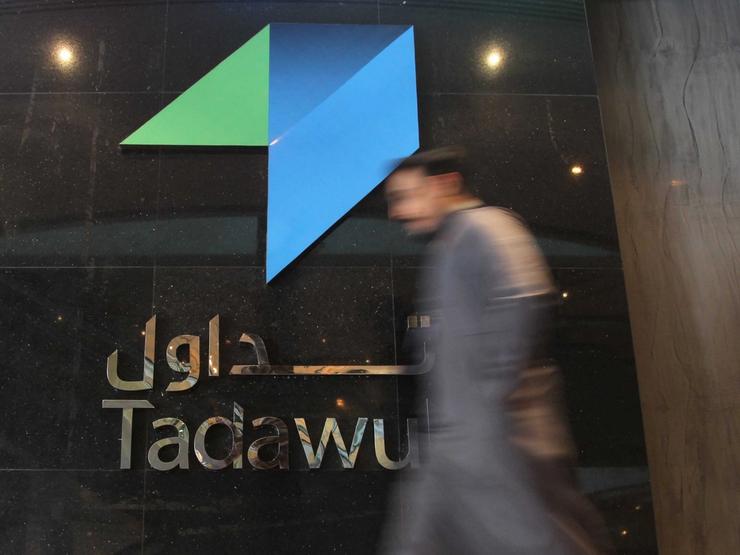 An investor walks at the Saudi Stock Exchange.