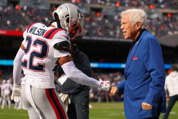 Owner Robert Kraft of the New England Patriots fist bumps Marco Wilson #22 prior to the game against the Chicago Bears at Soldier Field on November 10, 2024 in Chicago, Illinois.
