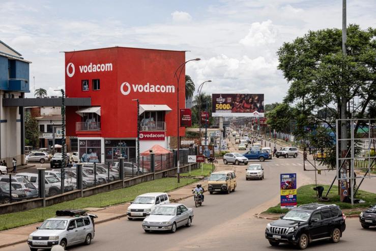 Vehicles drive past a Vodacom building in Lubumbashi, DR Congo.