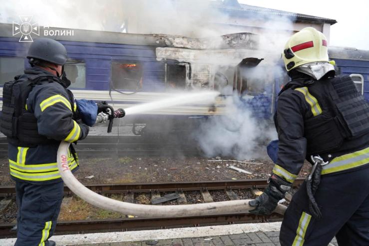 Firefighters extinguish a car of a passenger train hit by a Russian drone strike in Lutsk, Ukraine.