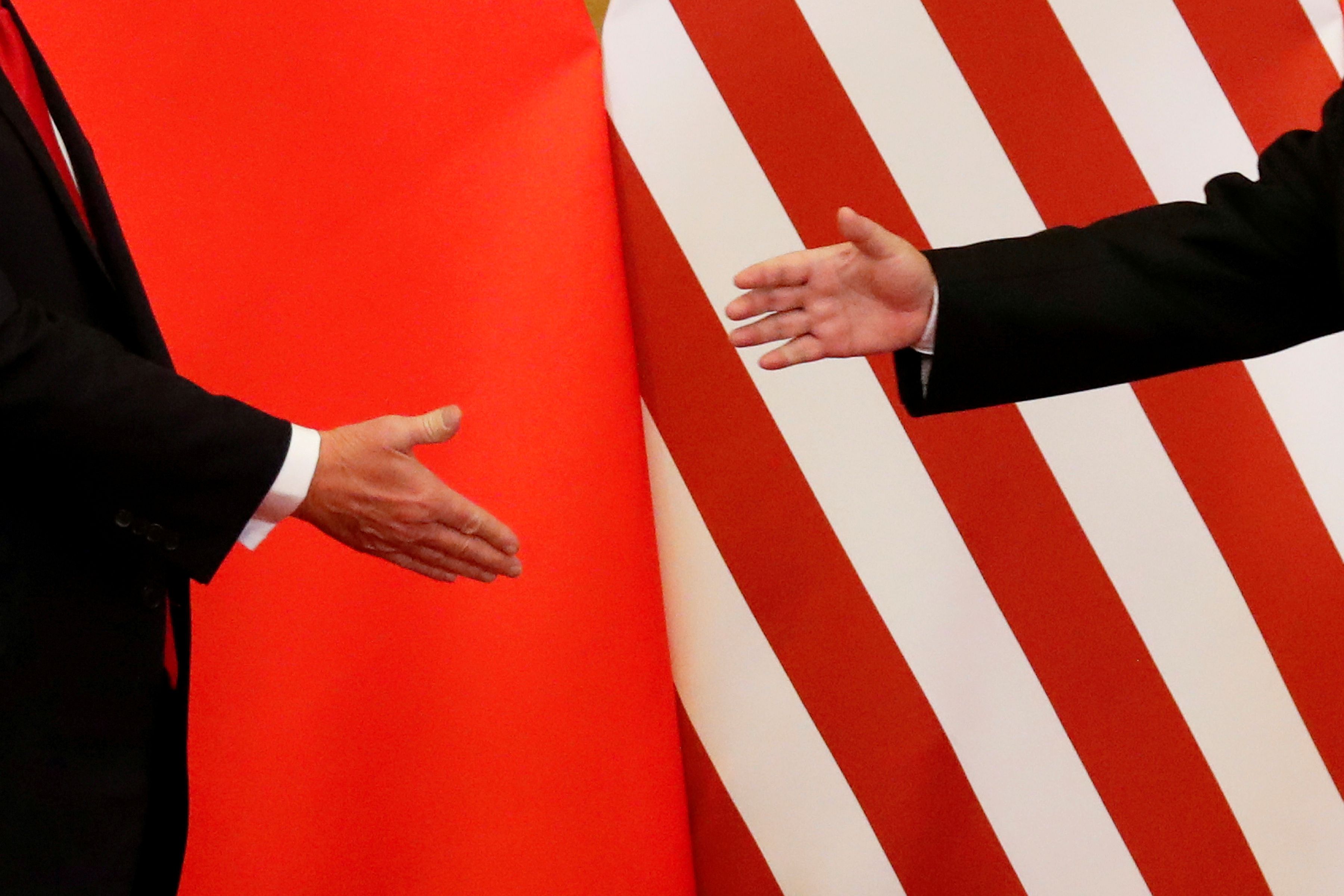 US President Donald Trump and China’s President Xi Jinping shake hands after making joint statements at the Great Hall of the People in Beijing, China, November 9, 2017. 