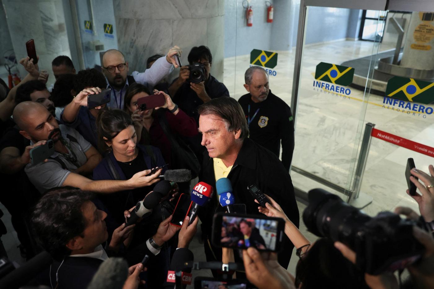 Brazil's former President Jair Bolsonaro speaks with media as he arrives at the airport in Rio de Janeiro, on the day the Electoral Justice continues the trial to determine his political rights, Brazil June 29, 2023. REUTERS/Pilar Olivares