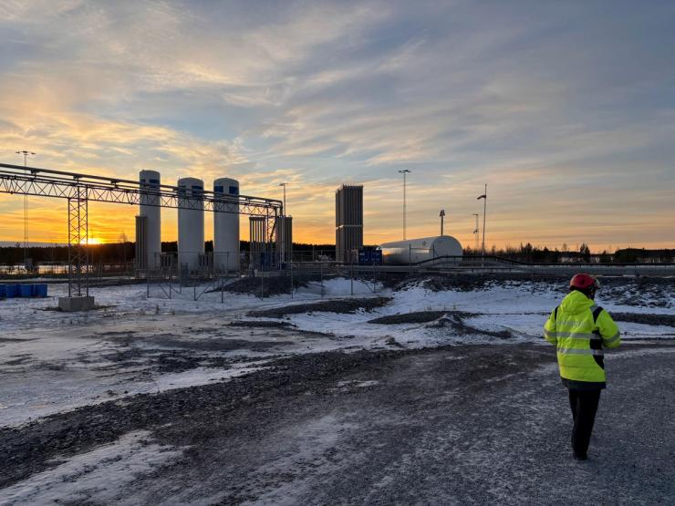 A man walks near the hydrogen supply line for Hybrit’s “green” steel plant in Lulea.