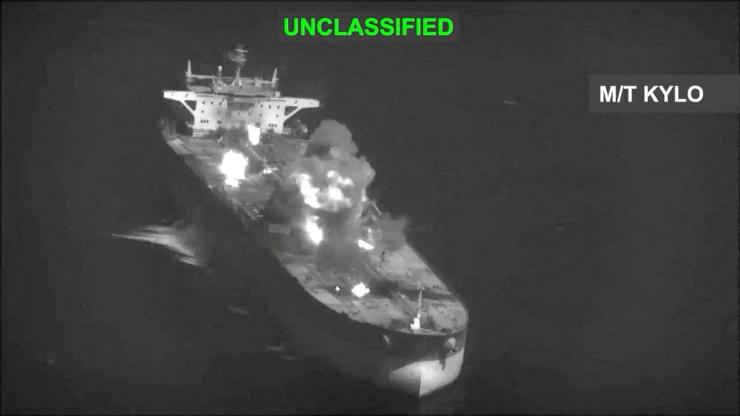 Fire and smoke rise during what CENTCOM says are strikes on Iranian oil carriers
