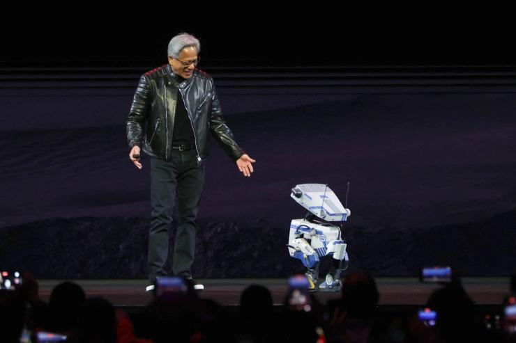 Jensen Huang delivers the keynote address at Nvidia’s GTC conference, and smiles down at Nvidia’s humanoid robot.